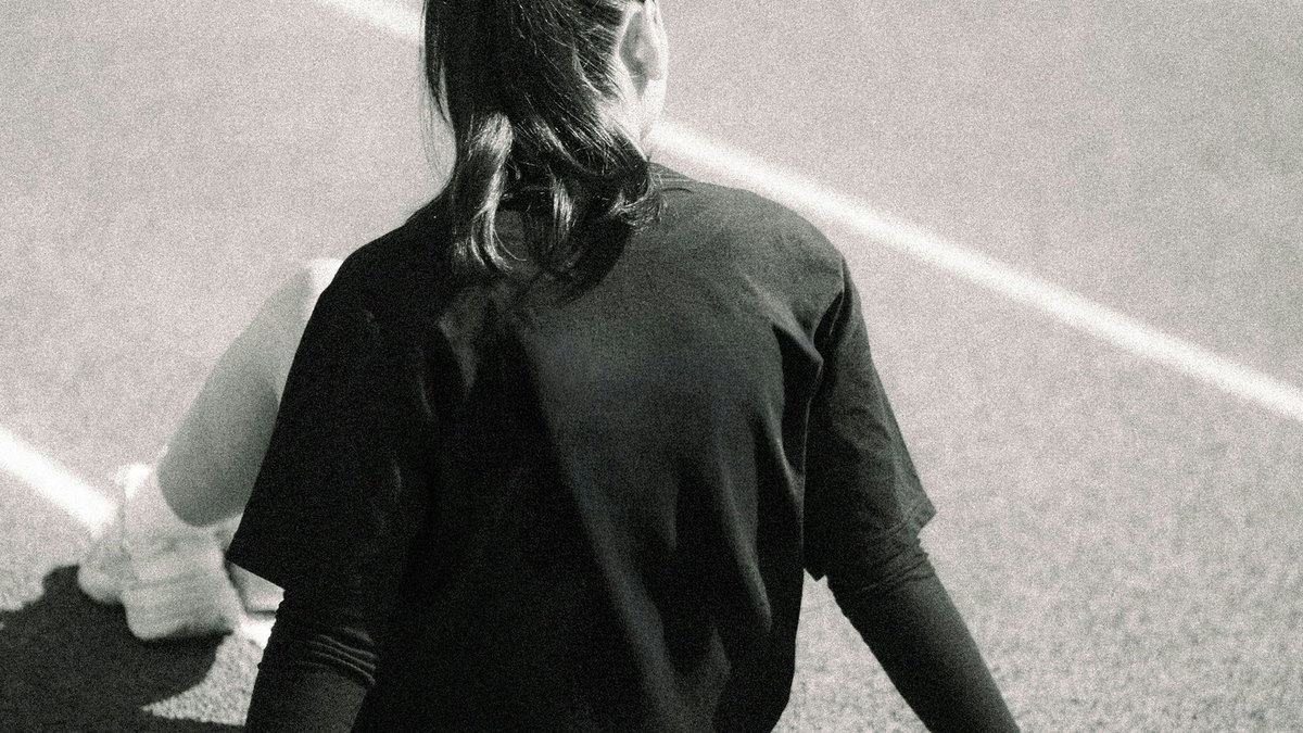 Athlete sitting quietly on the track after a hard training moment