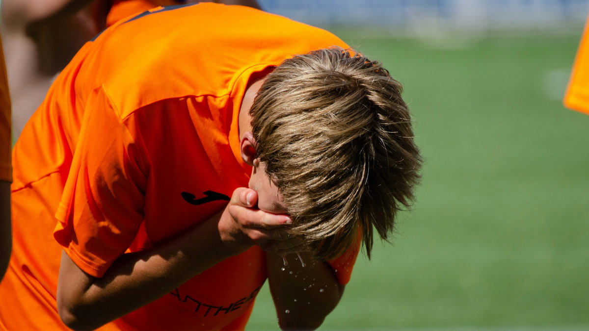 Exhausted soccer player pausing on the field