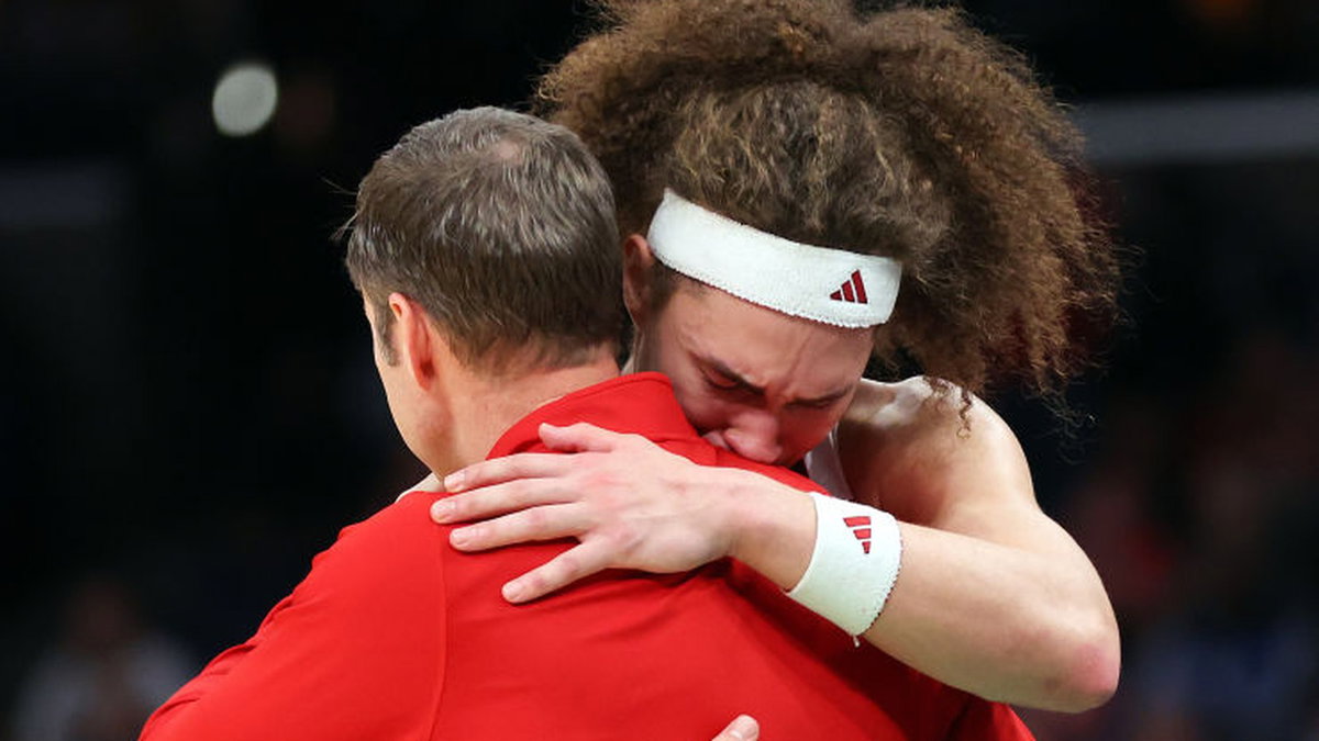 Young athlete being comforted after a game