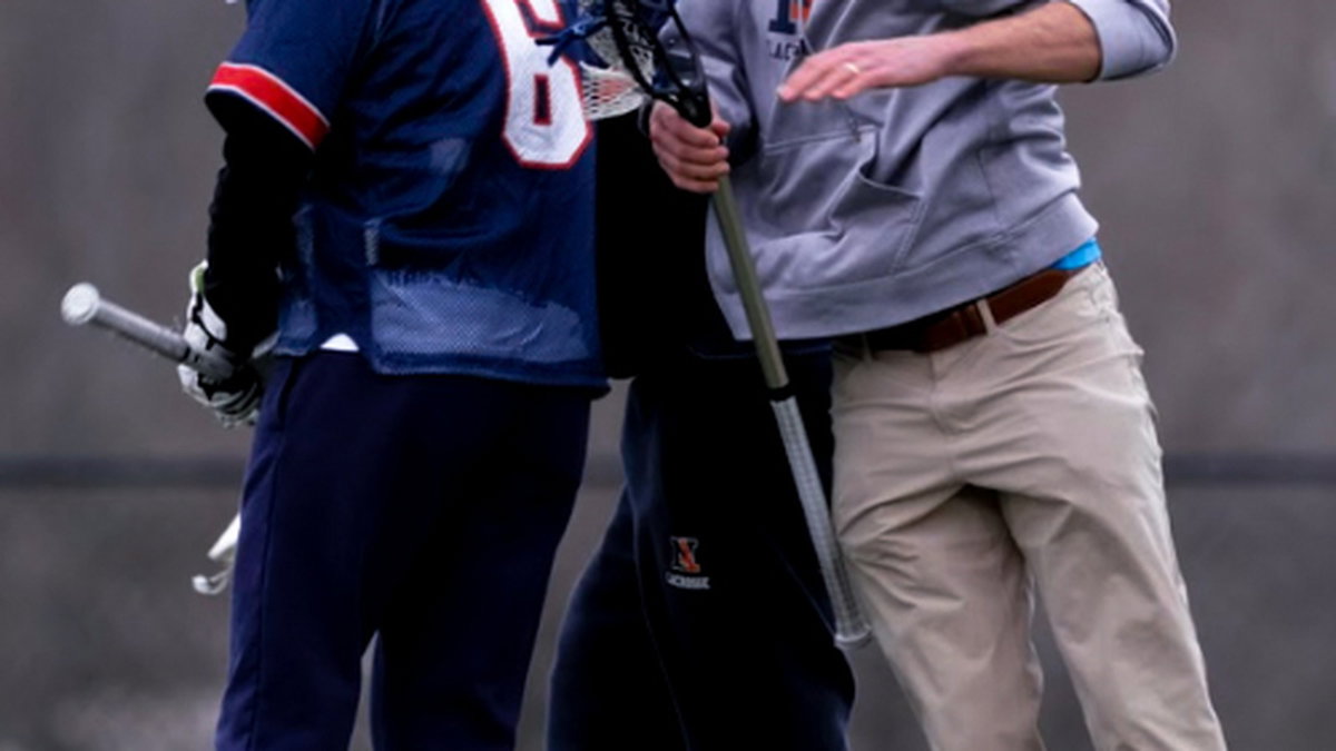 Coach speaking with athletes during practice
