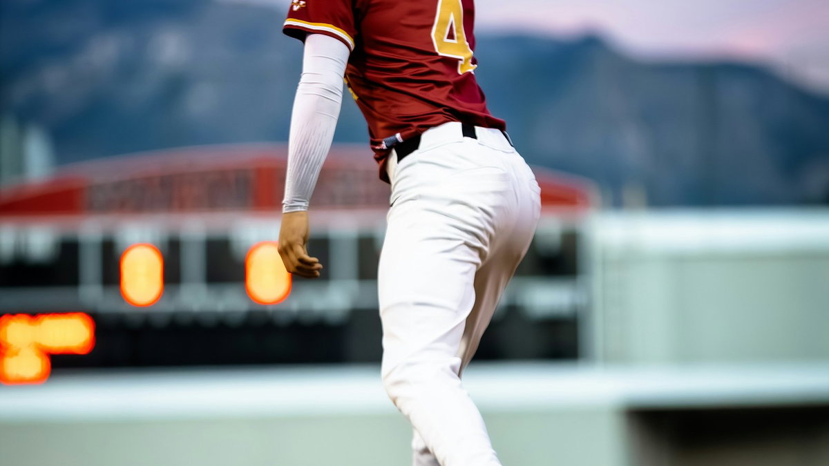 Baseball player catching a ball at dusk