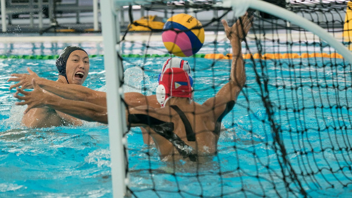 People playing volleyball in a pool